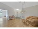 Bright living room features laminate wood flooring and neutral paint at 32942 Rambling Oaks Ct, Leesburg, FL 34748