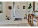 Bright and airy foyer featuring tile flooring, white door and stylish decor at 3507 Arlington Ridge Blvd, Leesburg, FL 34748