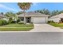 Charming single-story home with well-maintained lawn, mature landscaping, and a two-car garage at 3507 Arlington Ridge Blvd, Leesburg, FL 34748