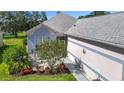 Home's exterior with lovely landscaping, garden and walkway to the front door, creating a welcoming entrance at 3601 Mount Hope Loop, Leesburg, FL 34748