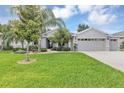 Charming single Gathering home features a well-manicured lawn and mature landscaping at 3681 Arlington Ridge Blvd, Leesburg, FL 34748