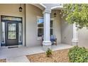 Cozy covered front porch with seating creates a warm and welcoming entrance at 3681 Arlington Ridge Blvd, Leesburg, FL 34748