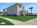 Well-maintained home featuring manicured landscaping and a vibrant palm tree at 5177 Blanket Flower St, Apopka, FL 32712