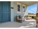 Inviting porch featuring comfortable armchairs, perfect for relaxing and enjoying the outdoors at 5177 Blanket Flower St, Apopka, FL 32712