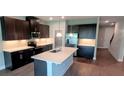 Modern kitchen featuring dark cabinets, stainless steel appliances, and a center island at 1867 Holden Ridge Lane, Clermont, FL 34715
