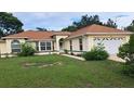 Attractive single-story home with well-manicured lawn and meticulous landscaping at 2947 Aldrich St, Eustis, FL 32726