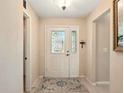 Welcoming foyer with a decorative glass front door, tile flooring, and neutral wall paint at 5317 Butterfly Ct, Leesburg, FL 34748