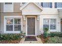 Inviting townhouse entrance with neat landscaping, neutral tones, and a well-kept walkway at 4904 Sw 45Th St, Ocala, FL 34474
