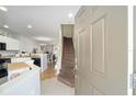 Bright entryway with stairs and open-concept view of the kitchen and dining area at 4904 Sw 45Th St, Ocala, FL 34474