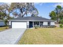 Beautifully renovated single-story home featuring a stone accented front and a well-manicured lawn at 781 Ne 130Th Ter, Silver Springs, FL 34488