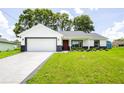 Beautiful single-story home with a new driveway, lush green lawn and inviting curb appeal at 13050 Ne 7Th Loop, Silver Springs, FL 34488