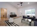 Living room with hardwood floors, staged furniture, and high ceilings at 600 Ne 130Th Ter, Silver Springs, FL 34488