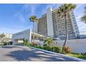 Beautiful condo building entrance with well-maintained landscaping and a covered drive through at 89 S Atlantic Ave # 204, Ormond Beach, FL 32176