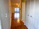 Long hallway with wood-look floors and access to living areas at 10730 Se 50Th Ave, Belleview, FL 34420