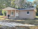 Newly constructed light brown single-story house with covered porch at 930 Nw 6Th Terrace Ter, Ocala, FL 34475