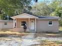 Newly constructed light brown single-story house with covered porch at 930 Nw 6Th Terrace Ter, Ocala, FL 34475