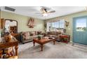 Living room with a sofa, wooden coffee table, and a view of the backyard at 5315 Nw 25Th Loop, Ocala, FL 34482