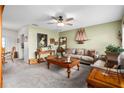 Spacious living room with a beige couch, wooden coffee table, and decorative items at 5315 Nw 25Th Loop, Ocala, FL 34482
