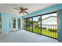 Bedroom with mirrored closet doors and sliding glass doors leading to balcony at 1 Tomoka Oaks Blvd # 102, Ormond Beach, FL 32174