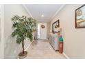 Bright and airy entryway with a console table and large plant at 8731 Sw 76Th Street Rd, Ocala, FL 34481