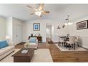 Bright living room with hardwood floors, dining area, and neutral decor at 11436 Sw 84Th Court Rd, Ocala, FL 34481