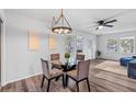 Bright dining area with glass table and four chairs, hardwood floors and modern light fixture at 7874 Midway Drive Ter # V201, Ocala, FL 34472