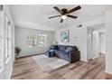 Living room with gray couch and wood-look floors at 7874 Midway Drive Ter # V201, Ocala, FL 34472