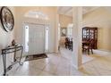 Inviting foyer with tile flooring, high ceilings, decorative lighting, and arched doorway at 11031 Sw 69Th Cir, Ocala, FL 34476