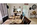 Dining room with a wooden table and chairs, looking into kitchen at 1326 Spring Lite Way, Orlando, FL 32825