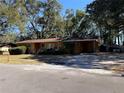 Yellow ranch home with attached carport and yard at 1705 Nw 17Th Ave, Ocala, FL 34475