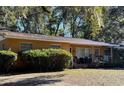 Ranch home with covered porch and large oak trees at 1705 Nw 17Th Ave, Ocala, FL 34475