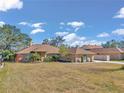 Two-story brick home with large yard and mature trees at 407 Soft Shadow Ln, Debary, FL 32713