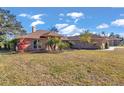 Brick home with palm trees and well-manicured lawn at 407 Soft Shadow Ln, Debary, FL 32713