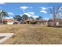 Front yard view of a house with a large lawn and driveway at 407 Soft Shadow Ln, Debary, FL 32713