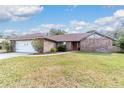 Charming single-story brick home featuring a well-manicured lawn and attached two-car garage at 2922 Se 38Th Pl, Ocala, FL 34480