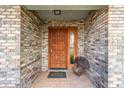 Inviting front entrance with a multi-paneled wood door and brick surround at 2922 Se 38Th Pl, Ocala, FL 34480