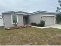 House exterior with gray siding and a two-car garage at 45 Orchid Ct, Kissimmee, FL 34759