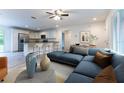 Open-concept living room flows into kitchen with stainless steel appliances and bar seating at 11 Locust Terrace Way, Ocala, FL 34472