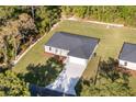 Aerial view of home with a driveway, spacious lawn, and a private wooded backyard at 11 Locust Terrace Way, Ocala, FL 34472