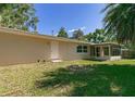 View of the backyard of a tan colored home with a screened in porch at 2060 Se 39Th St, Ocala, FL 34480