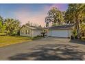 Inviting single-story home with a large driveway, two-car garage, and lush green lawn at 2060 Se 39Th St, Ocala, FL 34480