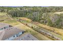 A view of a walking path running behind a row of houses in a community with mature trees at 5341 Nw 48Th Pl, Ocala, FL 34482