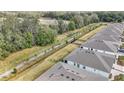 A view of a walking path running behind a row of houses in a community with mature trees at 5341 Nw 48Th Pl, Ocala, FL 34482