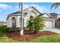 Beautiful home with arched windows, a two-car garage, and lovely landscaping at 2251 Oakington St, Winter Garden, FL 34787