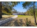 Exterior of a home featuring a well-manicured lawn, concrete driveway, and a three-car garage at 12880 Sw 66Th St, Ocala, FL 34481