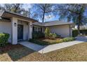 Welcoming front entrance with a modern front door, manicured landscaping, and elegant lighting at 1762 Ne 39Th St, Ocala, FL 34479
