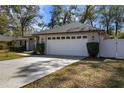 Exterior view of a home showcasing the large two-car garage and driveway at 1762 Ne 39Th St, Ocala, FL 34479