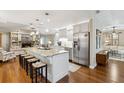 Bright kitchen featuring a large island with seating, modern appliances, and ample counter space at 906 Crestview Dr, Auburndale, FL 33823
