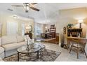 Open-concept living room with neutral tones, a ceiling fan, and seamless flow to the dining area at 906 Crestview Dr, Auburndale, FL 33823