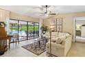 Cozy living room featuring sliding glass doors that open to the pool area and outdoor living space at 906 Crestview Dr, Auburndale, FL 33823